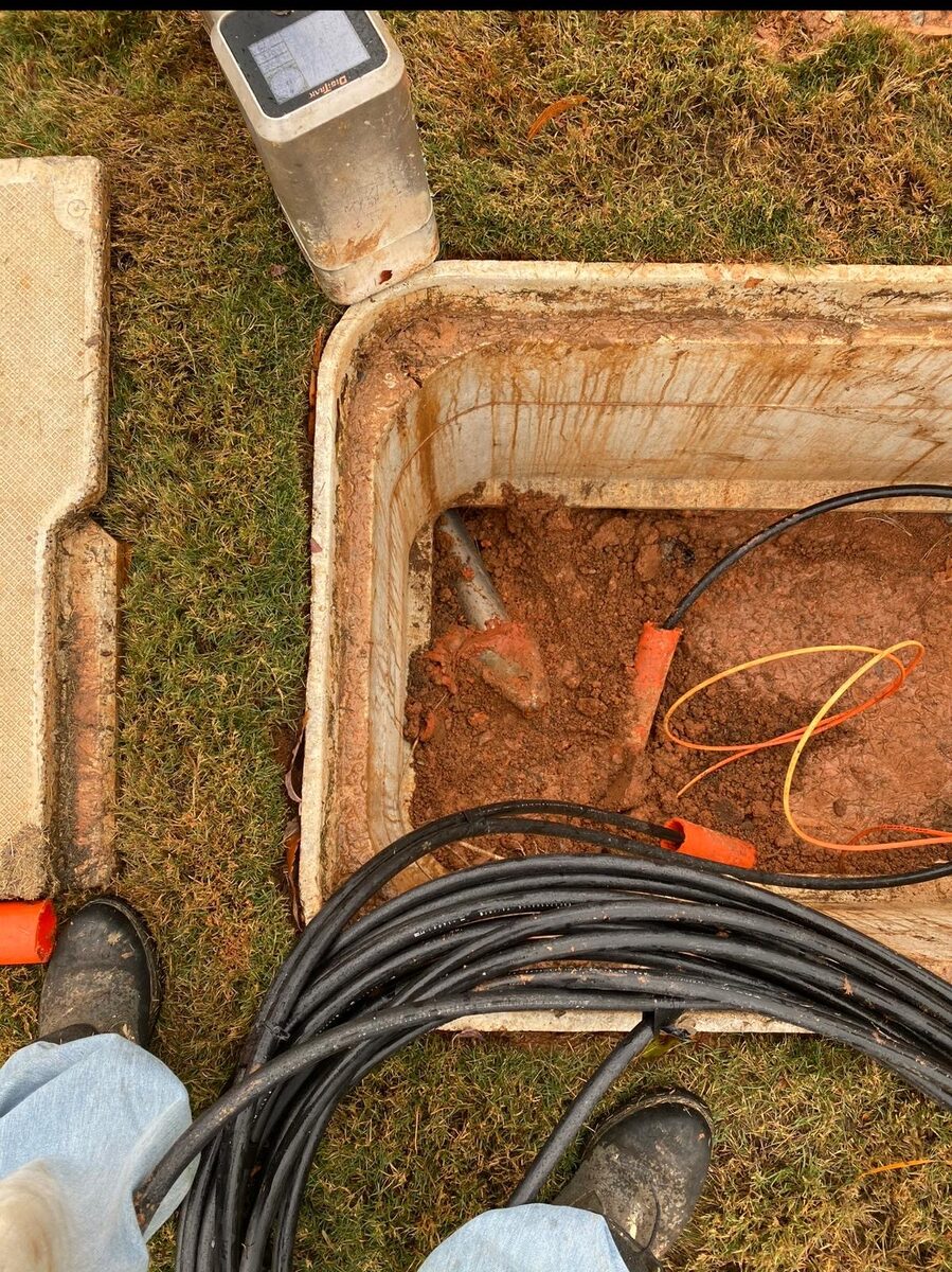 Underground utility handhole with cable pull work in progress